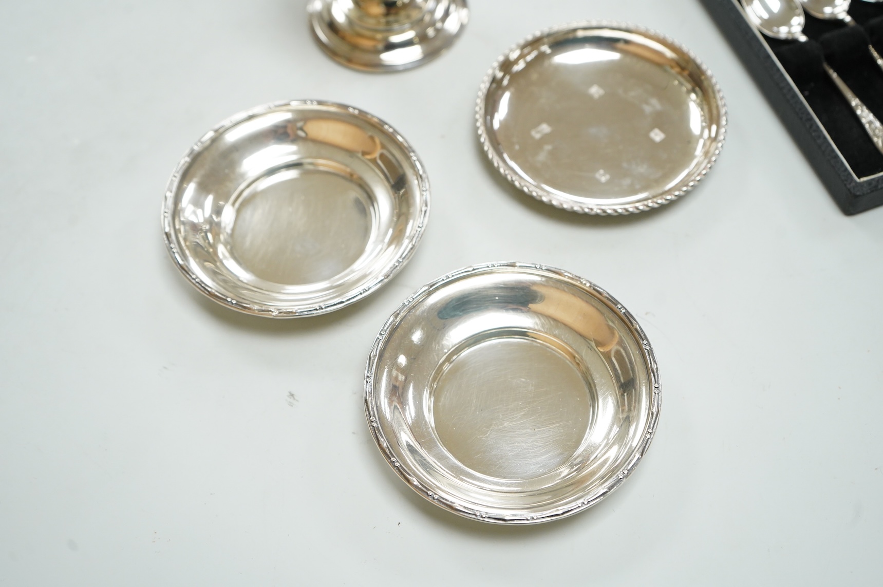 A George V silver sugar caster by Walker & Hall London 1932, 16cm, together with three silver nut dishes and a cased set of six silver coffee spoons.